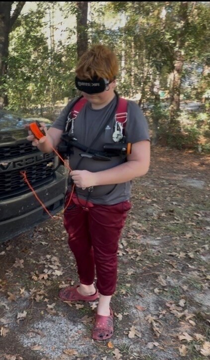 Malachi Jack practicing tactile guideline handling while wearing a blackout mask