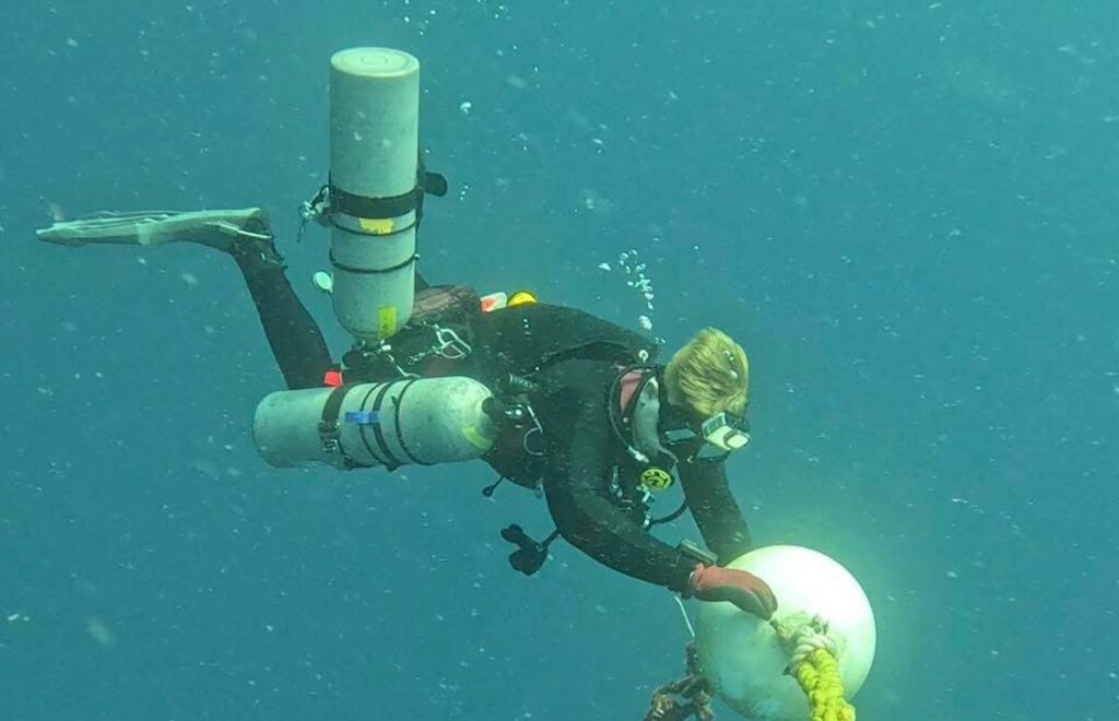 Malachi Jack handling a line and buoy during a technical dive